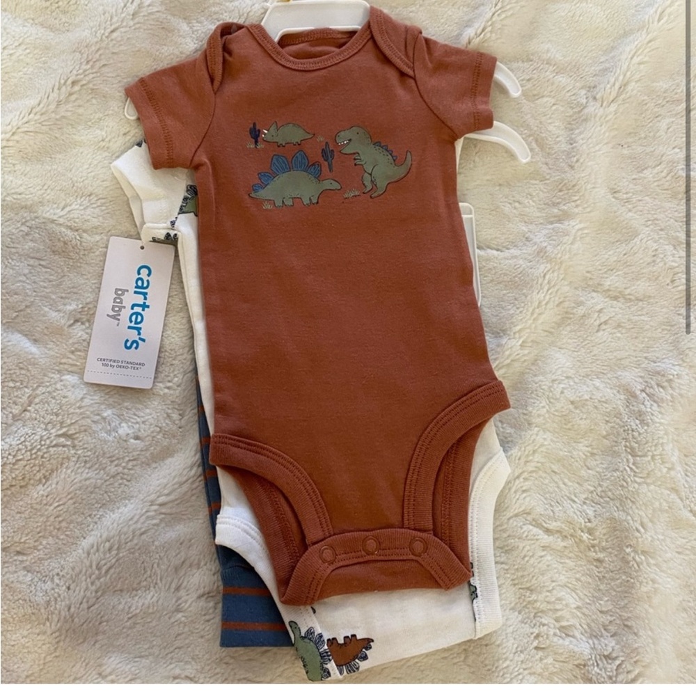 NWT 24 m dinosaur Carters two onesies with pants. Dinosaur patch on bottom.